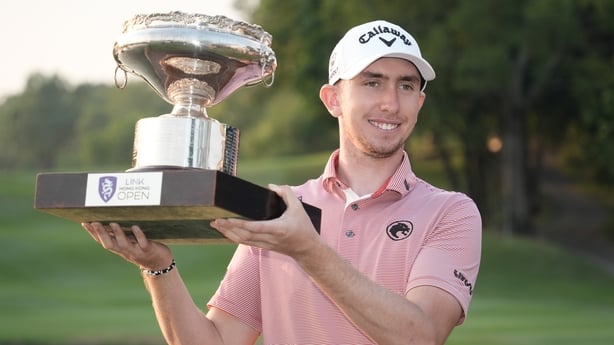 HONG KONG, CHINA - NOVEMBER 02: Tom McKibbin of Northern Ireland lifts the Link Hong Kong Open Trophy during a ceremony following the final round of the Link Hong Kong Open, as a part of The Open Qualifying Series at Hong Kong Golf Club on November 02, 2025 in Hong Kong, China. (Photo by Anthony Kwa