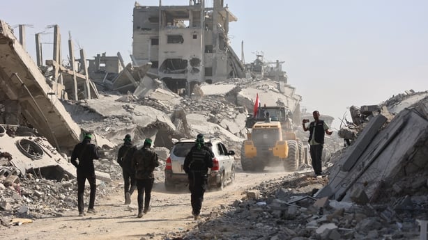 Armed Palestinian Hamas fighters along with members of the International Red Cross (ICRC) 