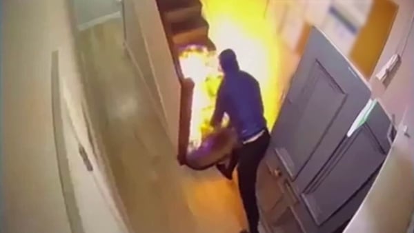 A fire being started on stairs at an IPAS centre