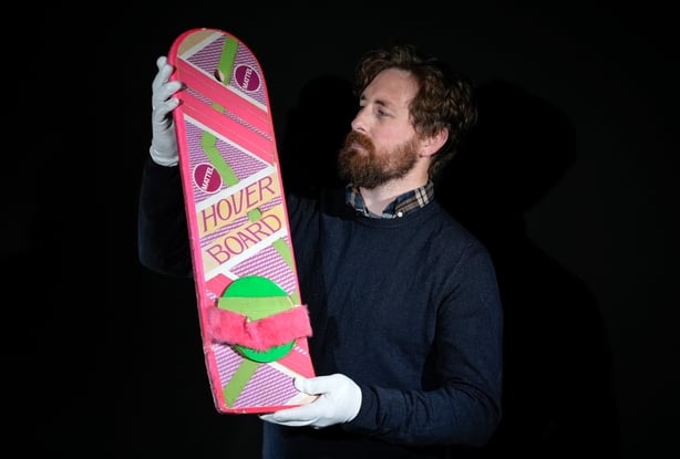 A Propstore employee looks at Marty McFly's (Michael J. Fox) Hoverboard from the 1989 and 1990 films Back to the Future Part II and Back to the Future Part III