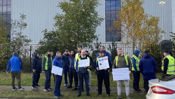Workers outside Fastway holding placards