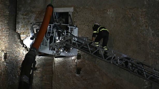 Firefighters enter the medieval tower "Torre dei Conti" where a worker is still trapped 