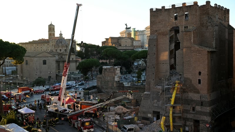 Firefighters work at the site after part of Torre dei Conti collapsed in Rome