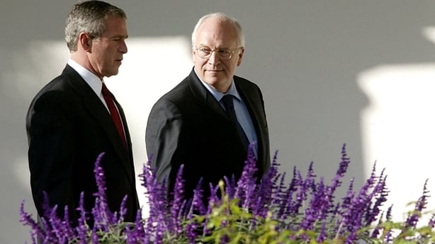George W. Bush walks with Vice President Dick Cheney along the colonnade at the White House in 2003
