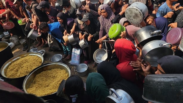 GAZA - NOVEMBER 4: A charity organization distributed hot meals to displaced Palestinians in the Al-Mawasi area of Khan Younis, southern Gaza Strip, on November 4, 2025. Large crowds, including women and children, formed long queues to receive food amid the ongoing humanitarian crisis caused by Isra