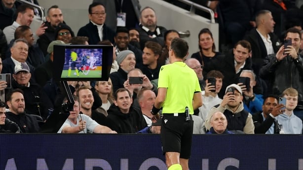 LONDON, ENGLAND - NOVEMBER 04: Referee Erik Lambrechts checks the Video Assistant Referee screen for a possible red card for Brennan Johnson of Tottenham Hotspur (not pictured) during the UEFA Champions League 2025/26 League Phase MD4 match between Tottenham Hotspur and F.C. Copenhagen at Tottenham 