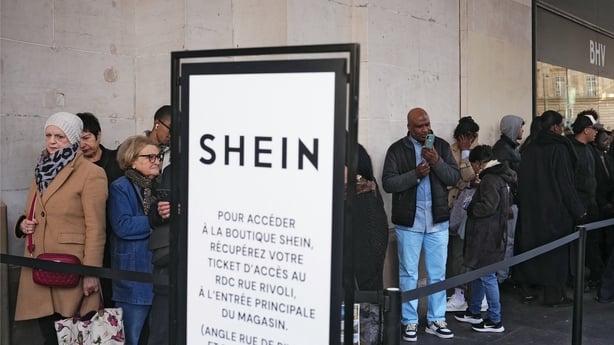 People queue outside a Shein shop in Paris