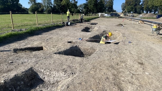 Pits are visible on an archaeological site