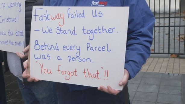 Someone holding a sign about the company Fastway