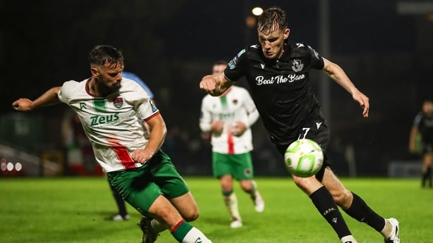 19 September 2025; Matt Healy of Shamrock Rovers in action against Greg Bolger of Cork City during the SSE Airtricity Men's Premier Division match between Cork City and Shamrock Rovers at Turner's Cross in Cork. Photo by Michael P Ryan/Sportsfile