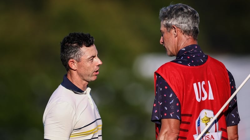 Rory McIlroy and Ted Scott, caddie to Scottie Scheffler, during the singles matches on the final day