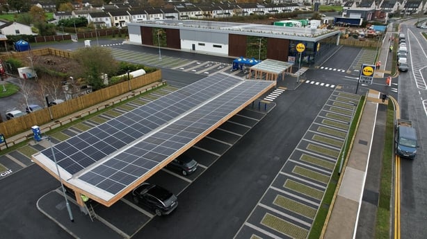 An image of solar panels in a car park
