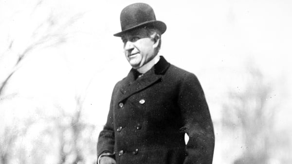 New York politician William Bourke Cockran standing with a cane.