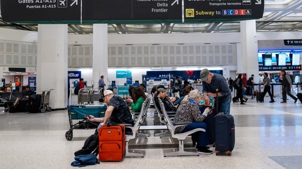 People sit on seats in a terminal lobby at the George Bush Intercontinental Airport in Texas.