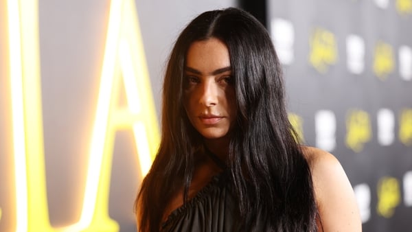 Charli XCX poses for a photo on the red carpet