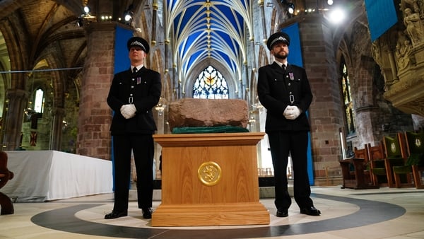 Two police officers guard the Stone of Destiny which is also known as the Stone of Scone,