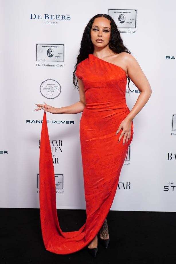 Jade wearing a slinky red gown 