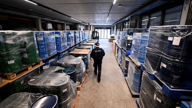 An employee walks inside the storage room of Tradium in germany