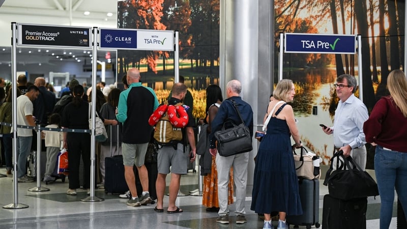 Travellers queue at a security checkpoint at George Bush Intercontinental Airport in Houston, Texas