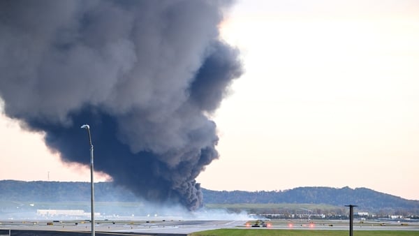 Fire and smoke mark where a UPS cargo plane crashed near Louisville Muhammad Ali International Airport