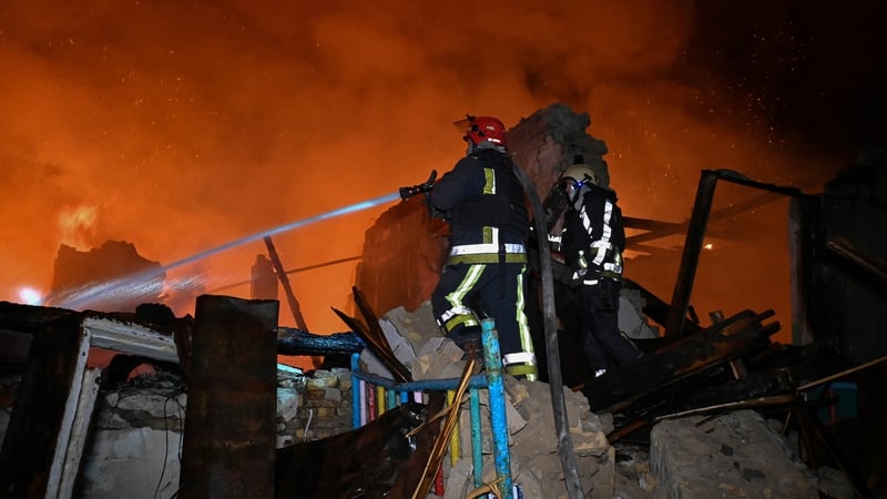 Ukrainian firefighters extinguish a fire at the site of a Russian drone strike in the city of Chuguiv, Ukraine yesterday