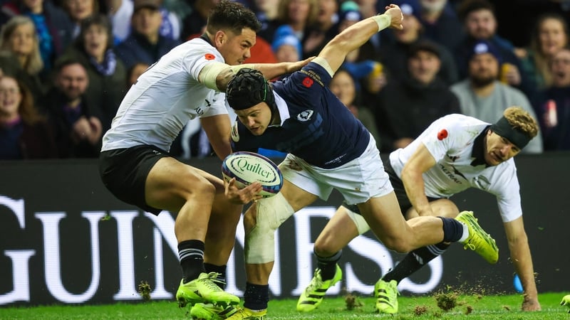 Scotland's Darcy Graham (R) and New Zealand's Cam Roigard (L) in action
