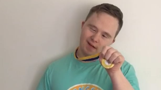 Liam Kovach holds his medal