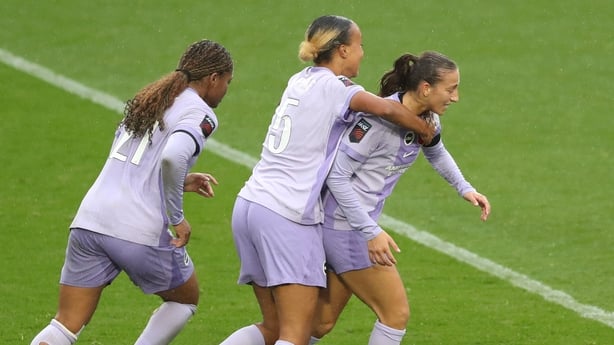 Rosa Kafaji of Brighton & Hove Albion celebrates scoring her team's first goal with teammates Madison Haley and Maelys Mpome during the Barclays Women's Super League match between Liverpool and Brighton & Hove Albion at The St Helens Stadium on November 09, 2025 in St Helens