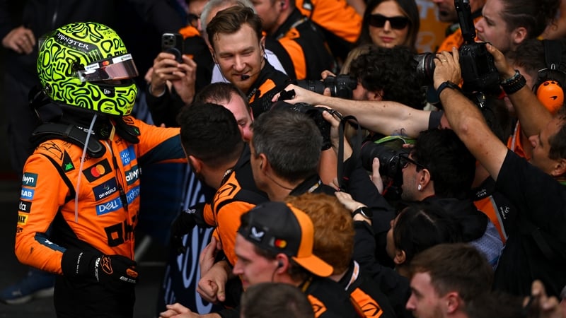 Lando Norris (L) celebrates with his McLaren team