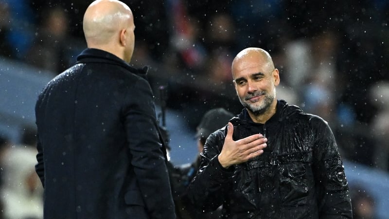 Manchester City manager Pep Guardiola (R) and Liverpool boss Arne Slot after the 3-0 win for City