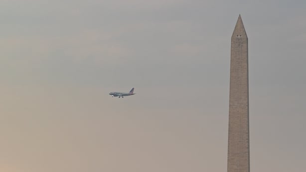  A plane flies by the Washington Monument