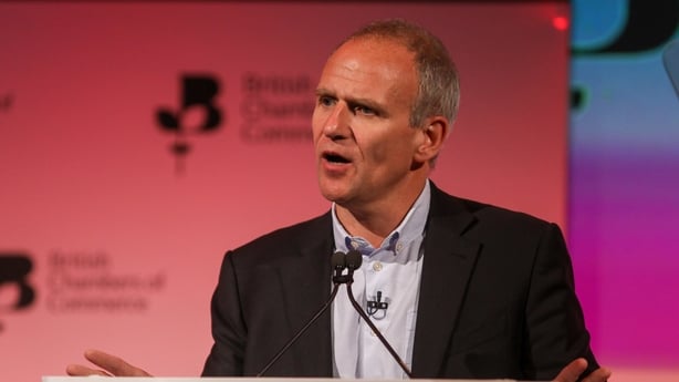Business man in a suit speakig at a conference