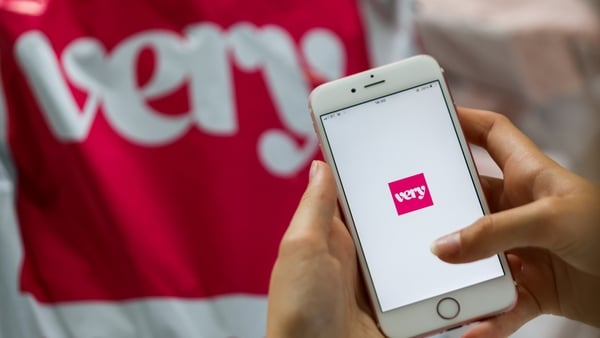 A person scrolls through The Very Group app on their smartphone