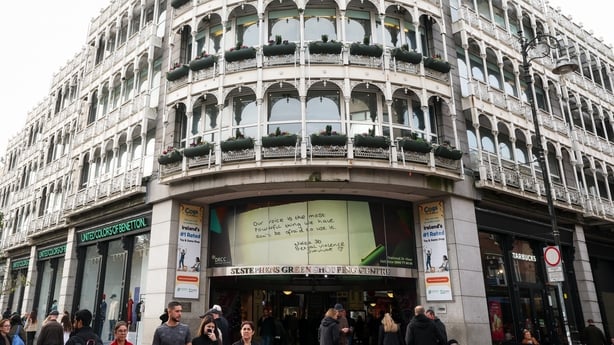 A sign of hope message can be seen on the front of a large building with dozens of glass windows