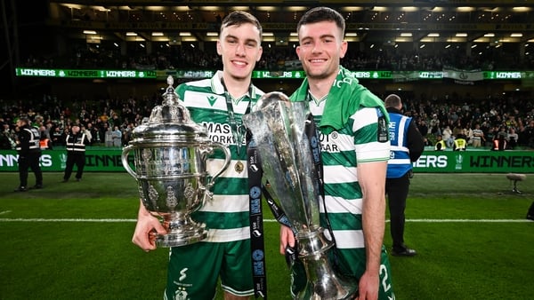 Shamrock Rovers players Matt Healy and Josh Honohan celebrates with the FAI Cup and SSE Airtricity Men's Premier Division trophy after the 2025 Sports Direct Men's FAI Cup Final match between Shamrock Rovers and Cork City at the Aviva Stadium in Dublin.