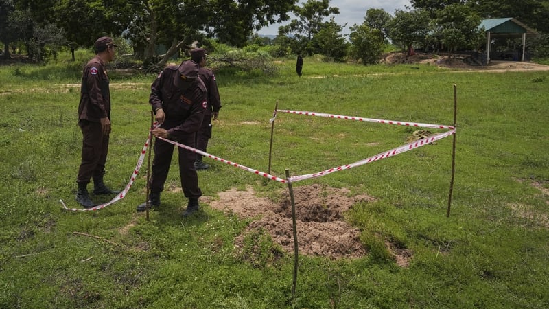 Cambodian teams work to detect and clear landmines along the Cambodia Thailand border in Banteay Ampil, Cambodia, in July