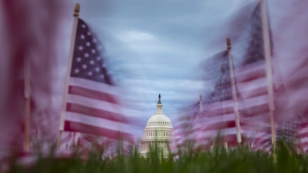 American flags fly in the wind along the National Mall on Capitol Hill in Washington, DC