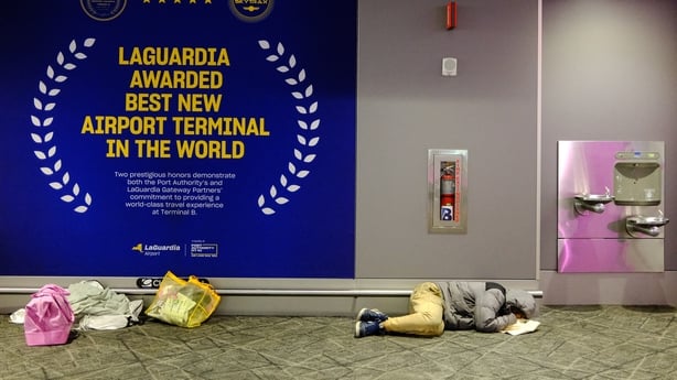 A man sleep on the ground of Terminal B at LaGuardia airport