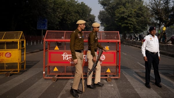 Police officers close to the site of an explosion near the Red Fort in New Delhi, India