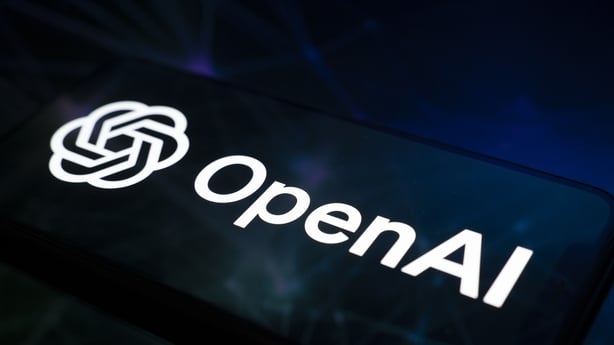 The OpenAI logo appears on a smartphone screen 