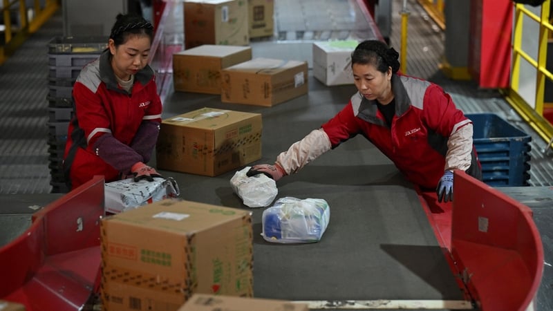 Chinese workers sort packages at JD's warehouse during Singles Day