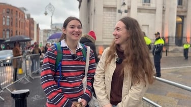 People gather outside Dublin Castle to see President Catherine Connolly depart for Áras an Uachtaráin
