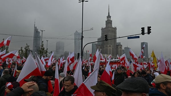 Participants carry national flags during the Independence March commemorating the 107th anniversary of Poland’s return to sovereignty