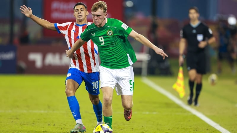 Republic of Ireland striker Michael Noonan takes on Paraguay's Carlos Franco