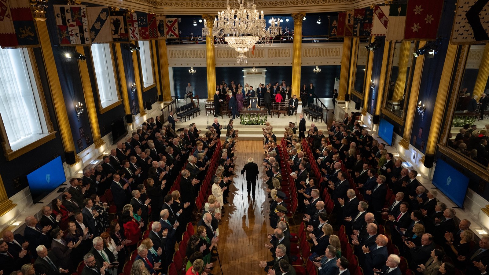 Michael D Higgins, whose 14 years as president ended on Monday 10 November, received a round of applause as he arrived in the hall
