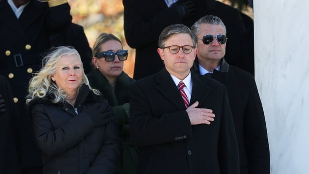 ARLINGTON, VIRGINIA - NOVEMBER 11: Speaker of the House Mike Johnson (R-LA) (2nd-R) and U.S. Secretary of War Pete Hegseth (R) participate in the Pledge of Allegiance during a ceremony at Memorial Amphitheater at Arlington National Cemetery to mark Veterans Day on November 11, 2025 in Arlington, Vir