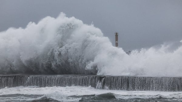 A wave crashes against a wall