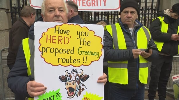 John O'Reilly holds a sign outside leinster house during a protest