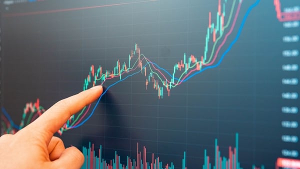 Finger of businessman checking stock market data