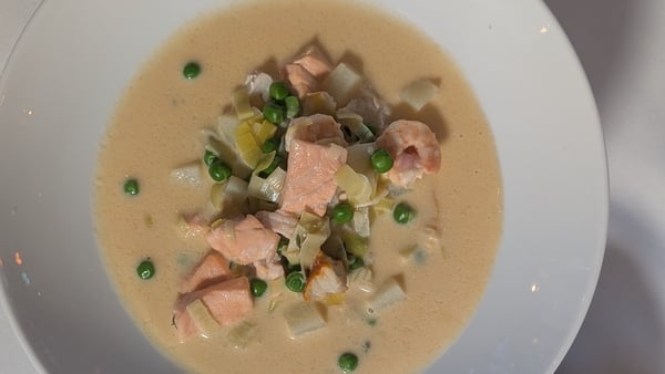 An overhead shot of a bowl of creamy seafood chowder